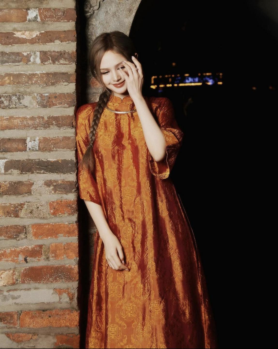 "Tho Doi Ao Dai set in orange wormsilk, traditional Vietnamese dress by Moc, artisan jacquard design."