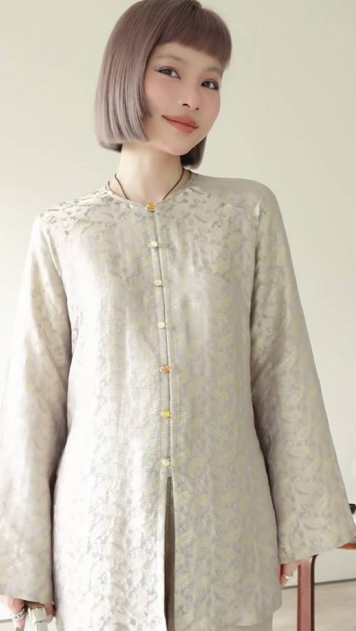 Authentic Vietnamese Ao Ba Ba in pearl beige wormsilk, detail of jacquard pattern and traditional tailoring