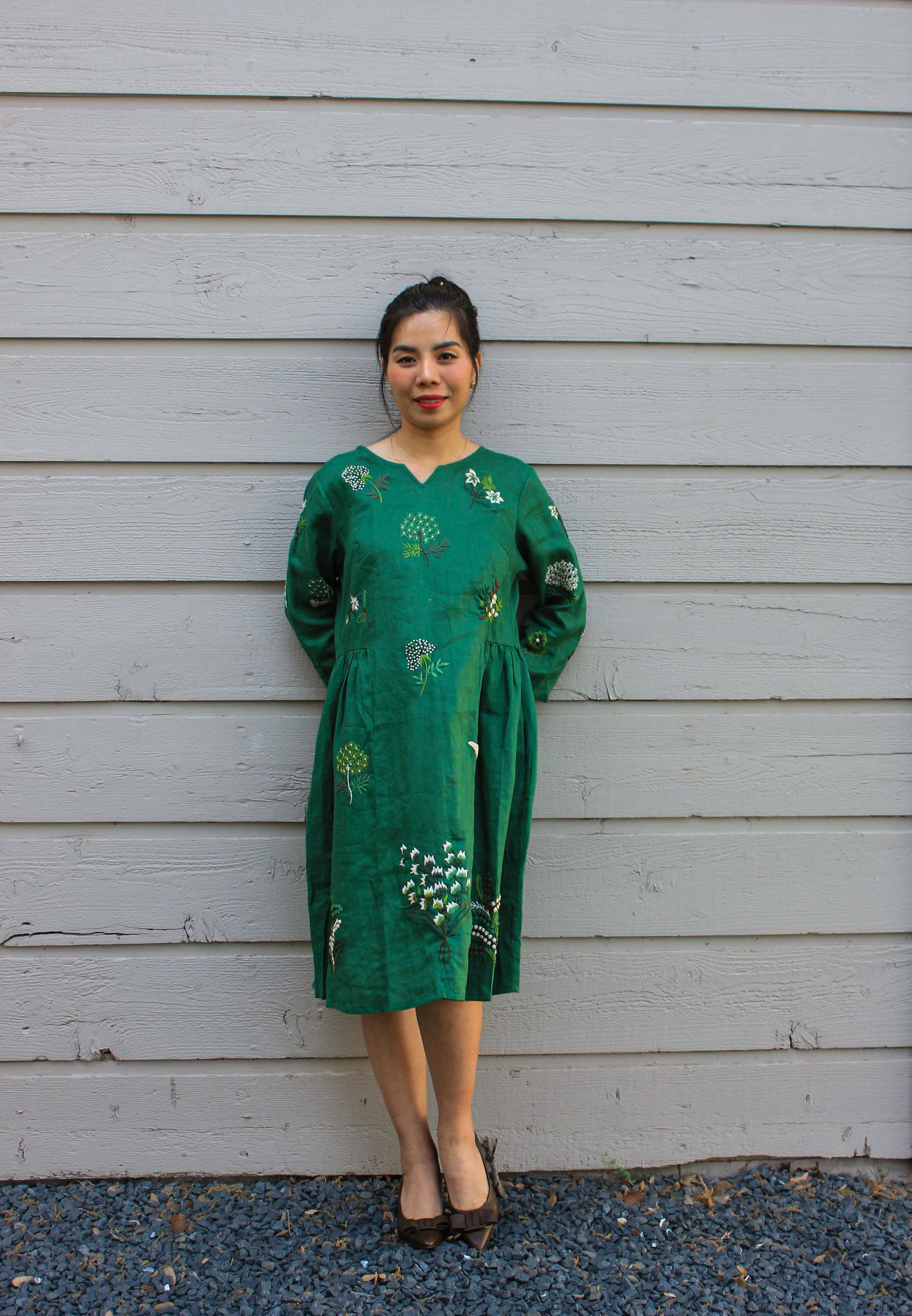 "Green embroidered linen dress 'Mimosa' by Huulala, featuring floral patterns, Vietnamese cultural design."
